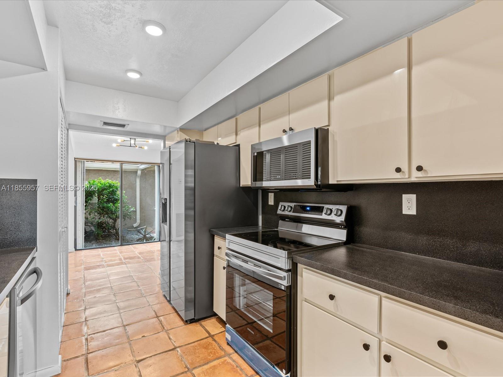 203 Bonnie Brae Way, Unit 34 Hollywood, FL 33021 - Photo 12 of 41 a kitchen with stainless steel appliances granite countertop a refrigerator and a sink