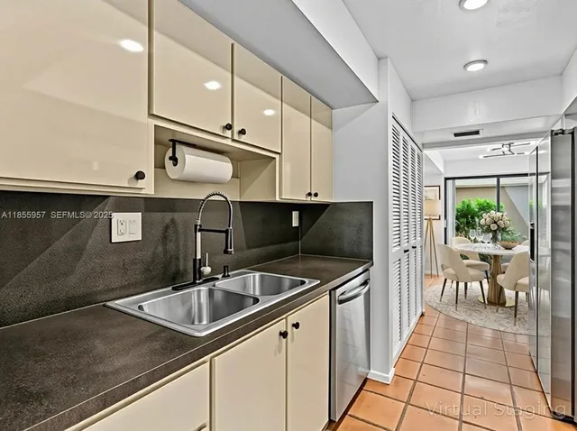 a kitchen with stainless steel appliances granite countertop a sink a stove and a microwave