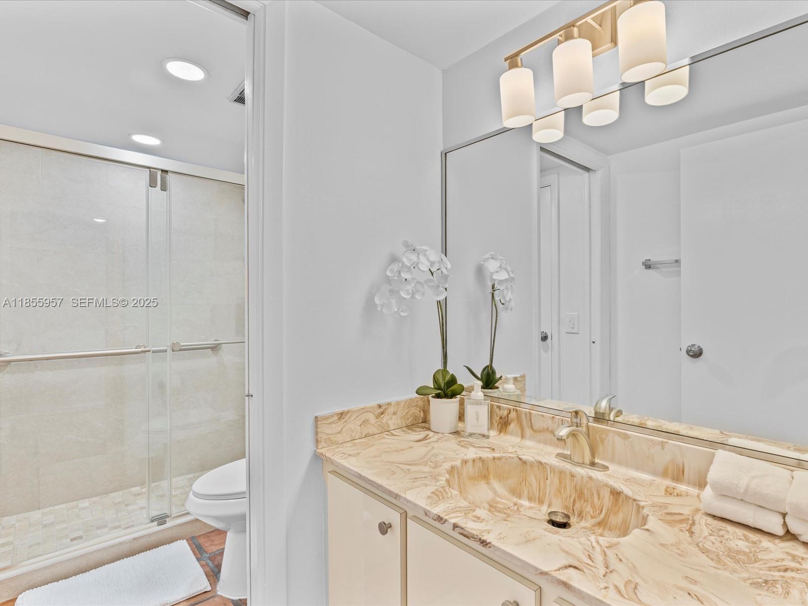 203 Bonnie Brae Way, Unit 34 Hollywood, FL 33021 - Photo 21 of 41 a bathroom with a granite countertop sink a toilet and shower