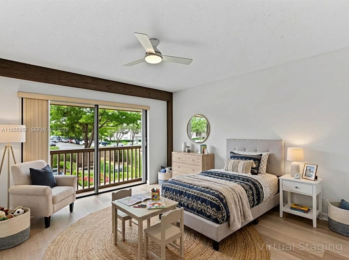 203 Bonnie Brae Way, Unit 34 Hollywood, FL 33021 - Photo 4 of 41 a bedroom with a bed a couch and a large window with the garden view