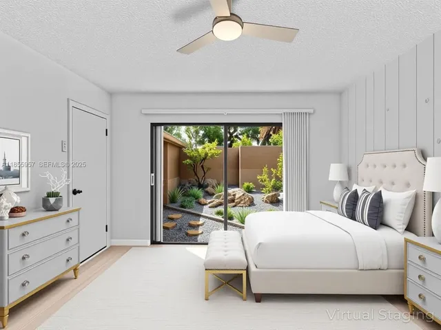 a bedroom with a bed and large windows