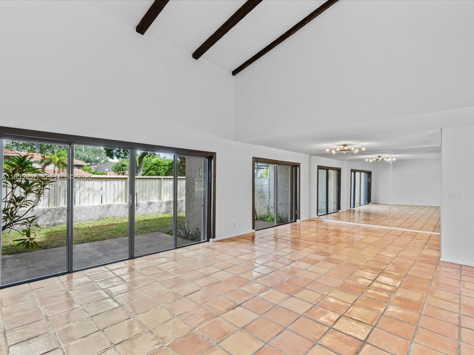 203 Bonnie Brae Way, Unit 34 Hollywood, FL 33021 - Photo 7 of 41 a view of an empty room with a balcony