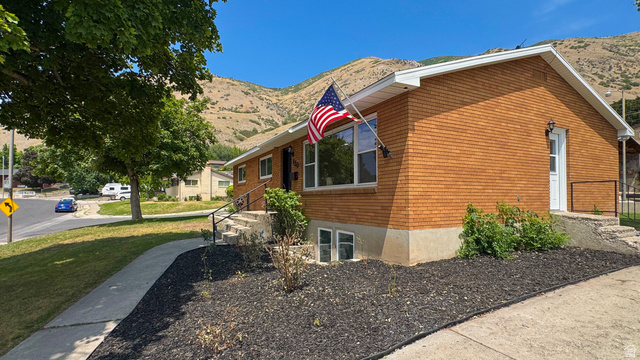 120 North 1230 E Street Springville, UT 84663 - Photo 59 of 60 Brick exterior with white trim, featuring a concrete walkway and steps