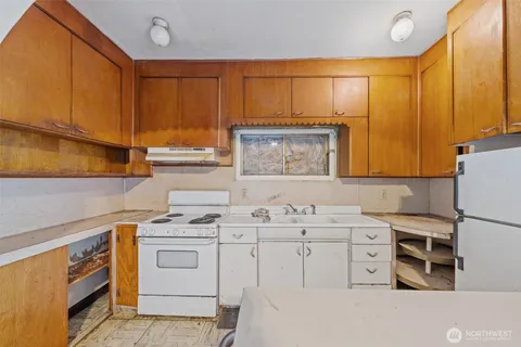 a kitchen with a sink a stove and cabinets