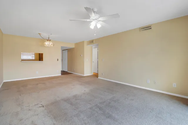 a view of an empty room with a ceiling fan