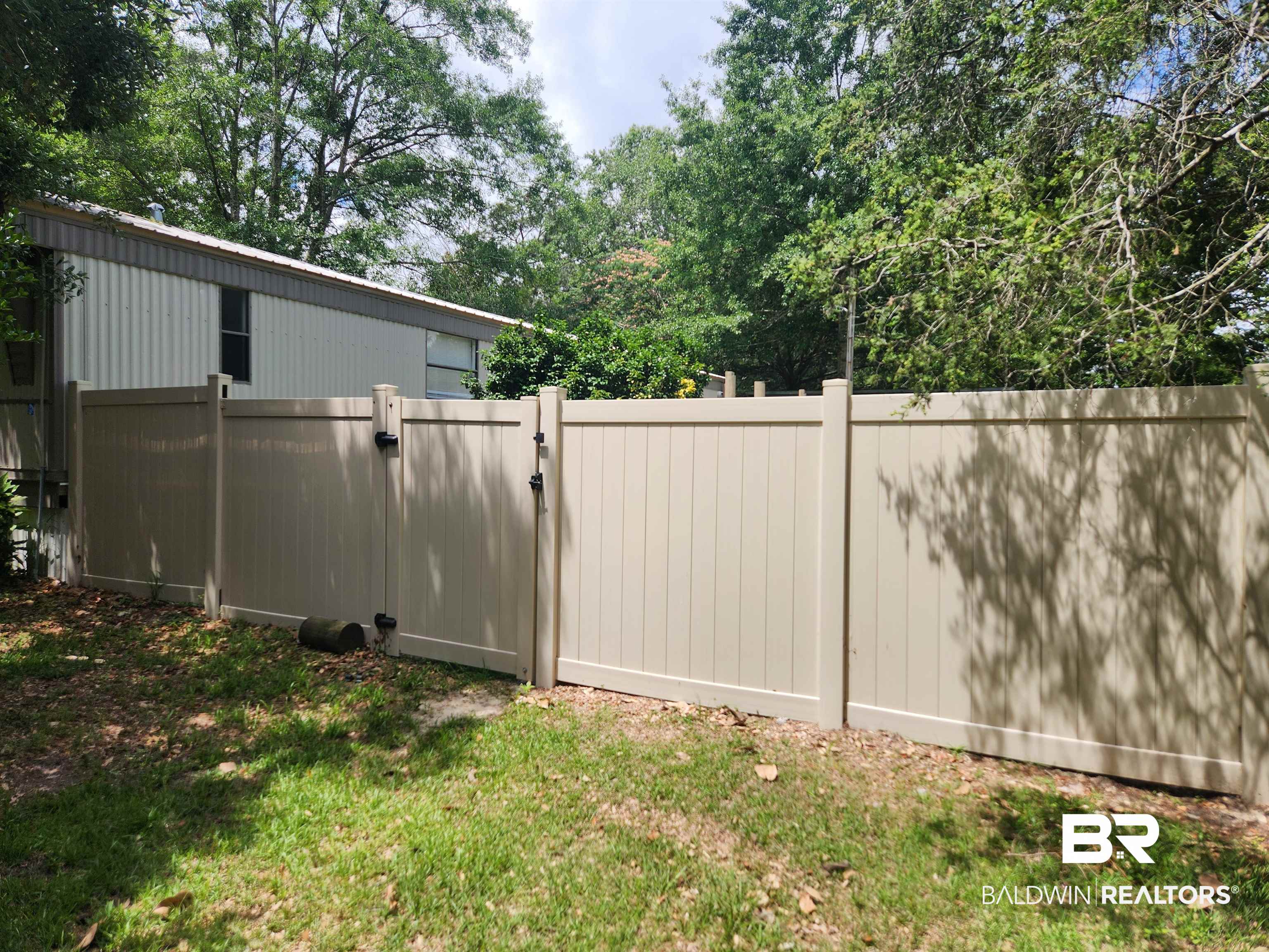 23051 Fritz Lane Foley, AL 36535 - Photo 3 of 26 Tan vinyl privacy fencing with dual gates