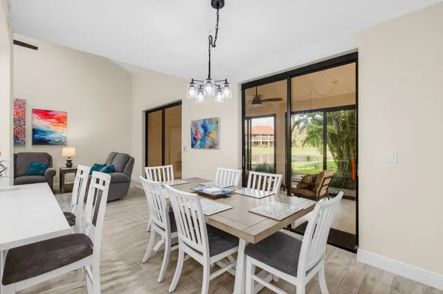 a bedroom with two beds and a dresser with wooden floor