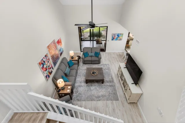 a living room with furniture and a floor to ceiling window