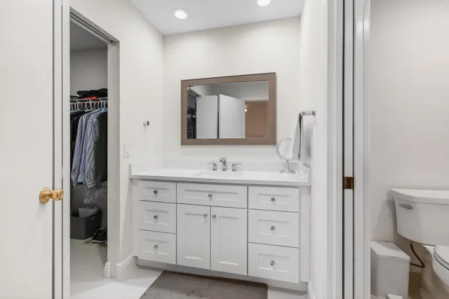 an aerial view of residential houses with outdoor space and trees