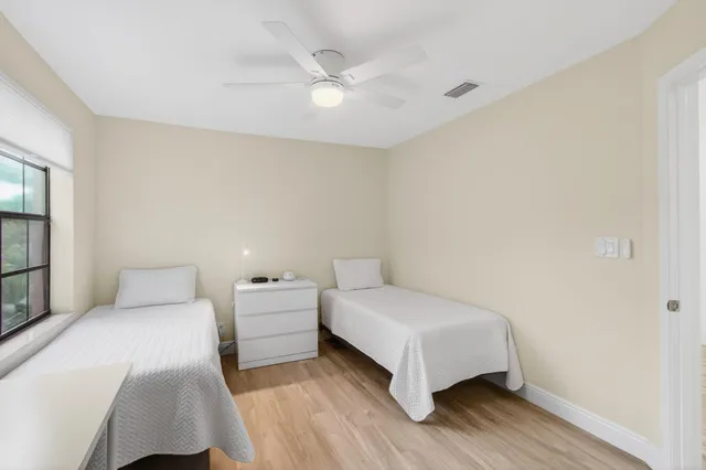 an aerial view of residential houses with outdoor space and lake view