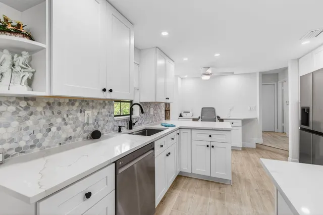 a living room with furniture a flat screen tv and a window