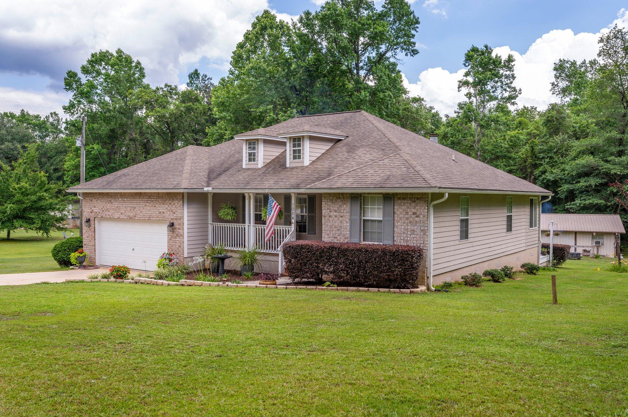 1084 Reeves Road Baker, FL 32531 - Photo 1 of 37 a front view of a house with a yard