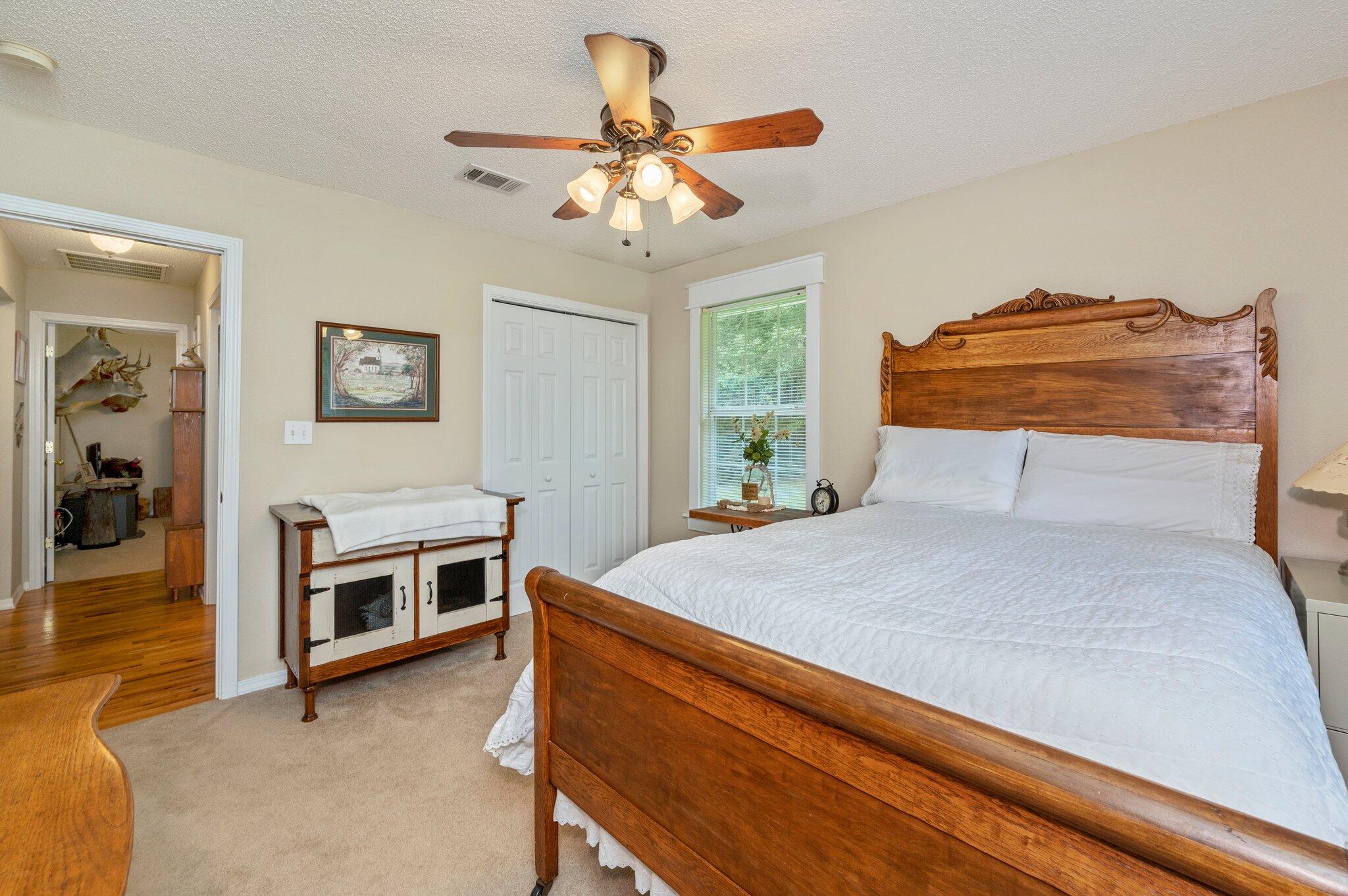 1084 Reeves Road Baker, FL 32531 - Photo 12 of 37 a bedroom with a bed and a chandelier