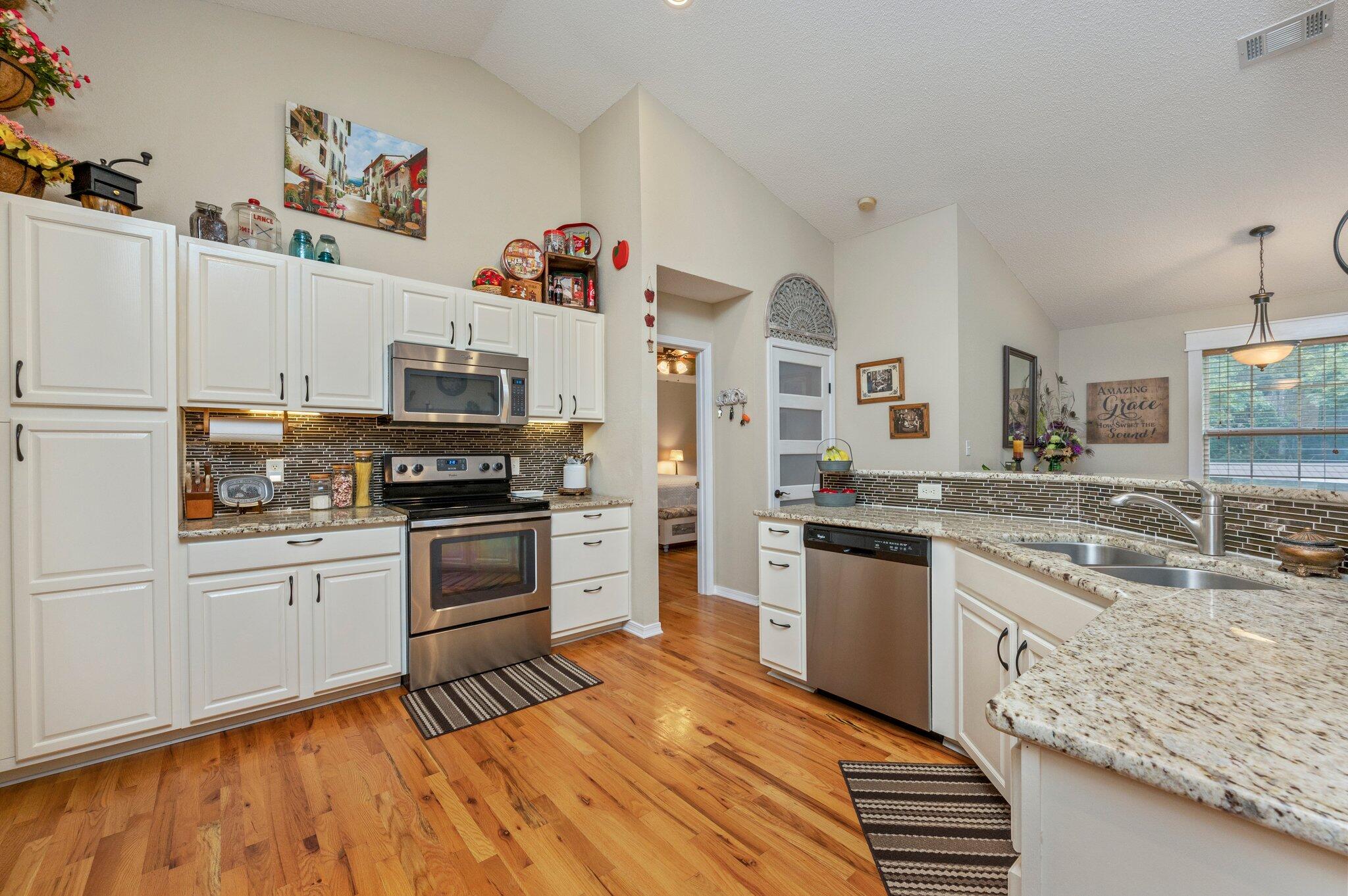 1084 Reeves Road Baker, FL 32531 - Photo 15 of 37 a kitchen with granite countertop appliances cabinets and a sink