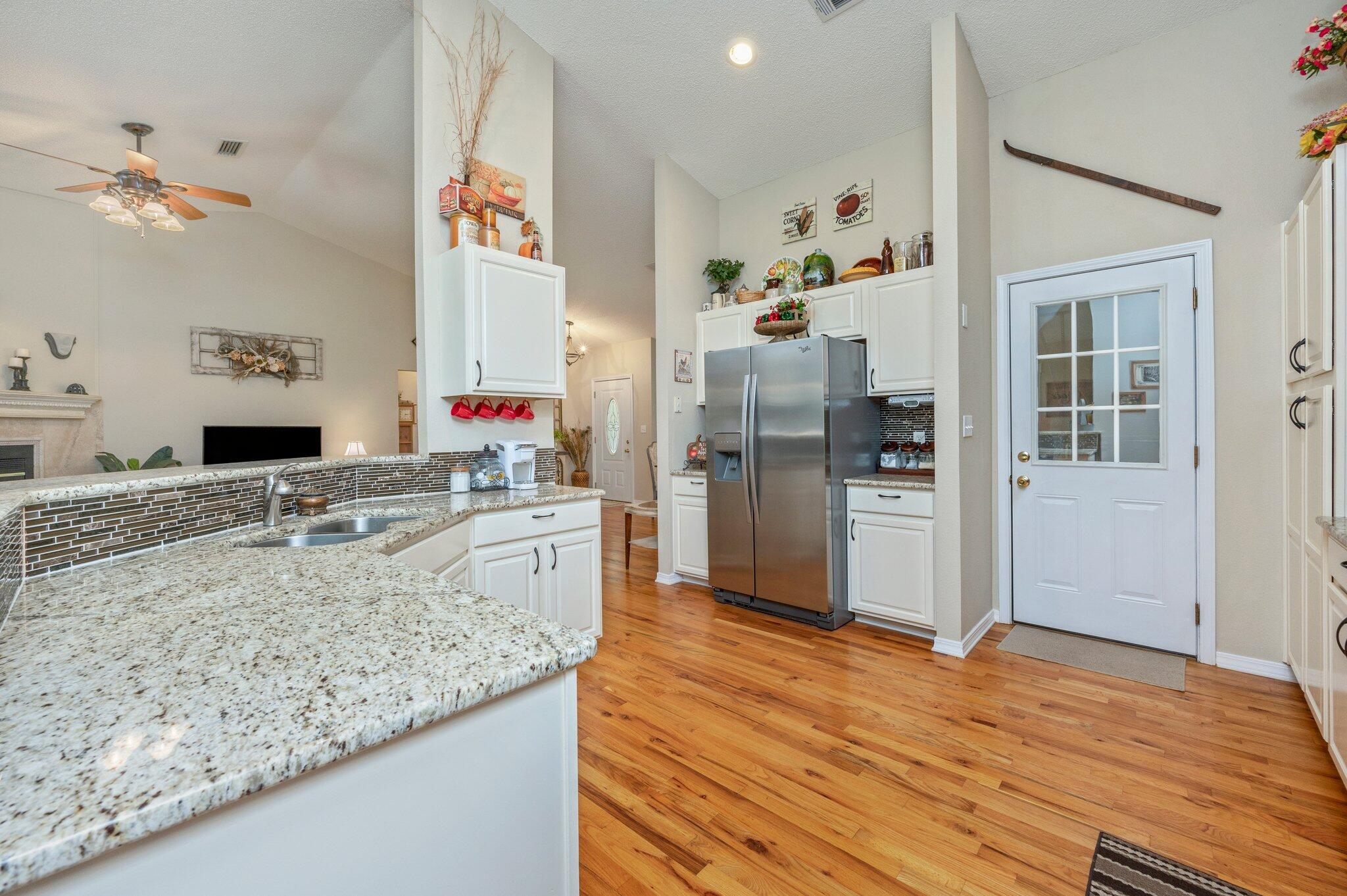 1084 Reeves Road Baker, FL 32531 - Photo 19 of 37 a kitchen with stainless steel appliances granite countertop a refrigerator and a sink