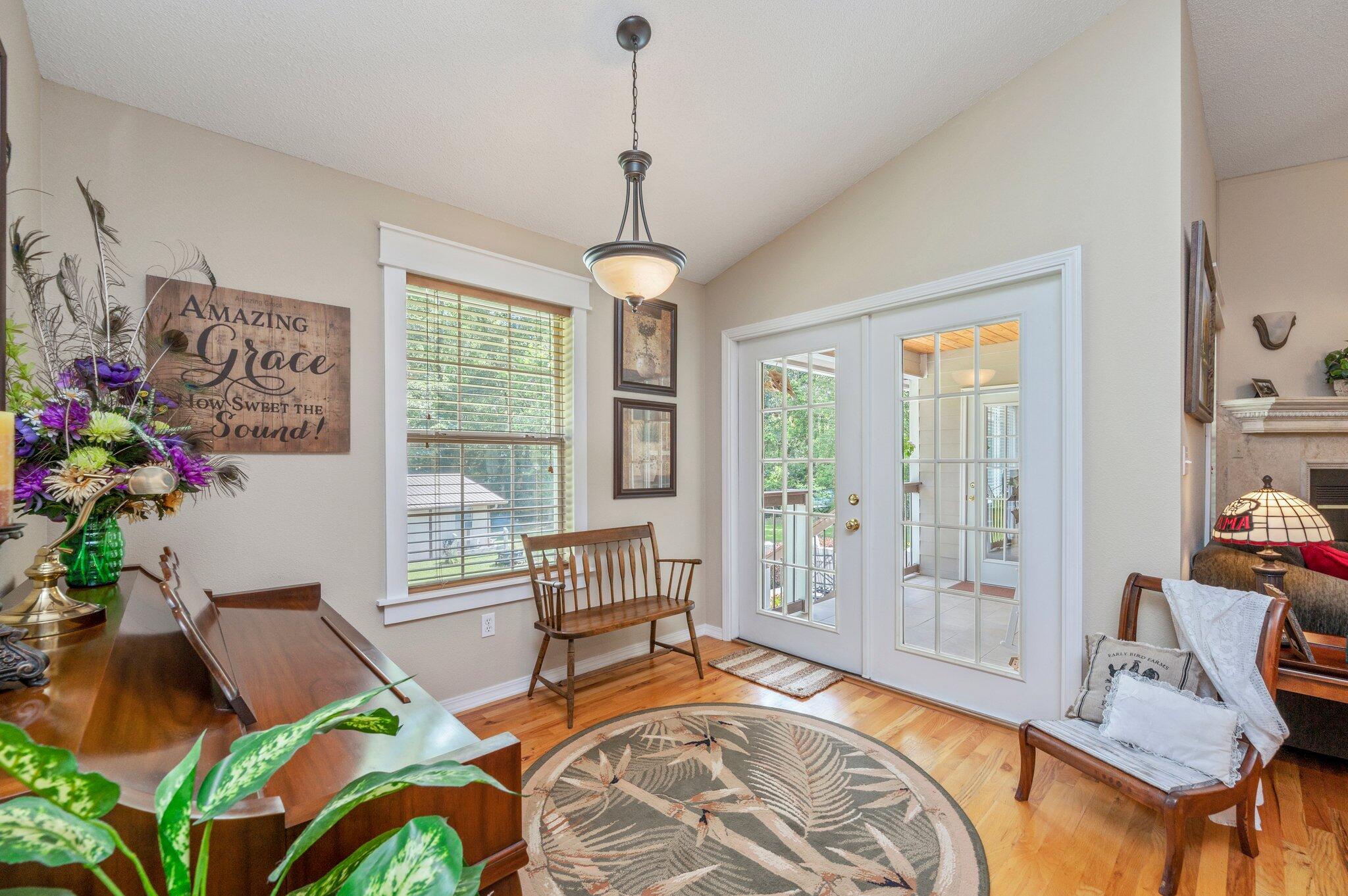 1084 Reeves Road Baker, FL 32531 - Photo 20 of 37 a living room with patio furniture and a chandelier