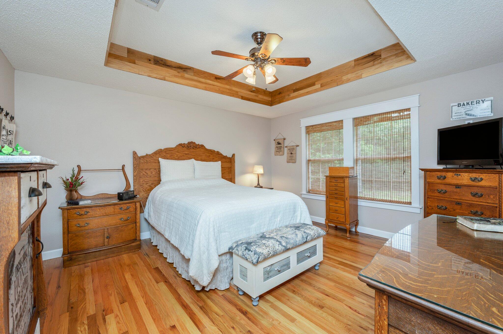 1084 Reeves Road Baker, FL 32531 - Photo 21 of 37 a bedroom with a bed and a flat tv screen on dresser