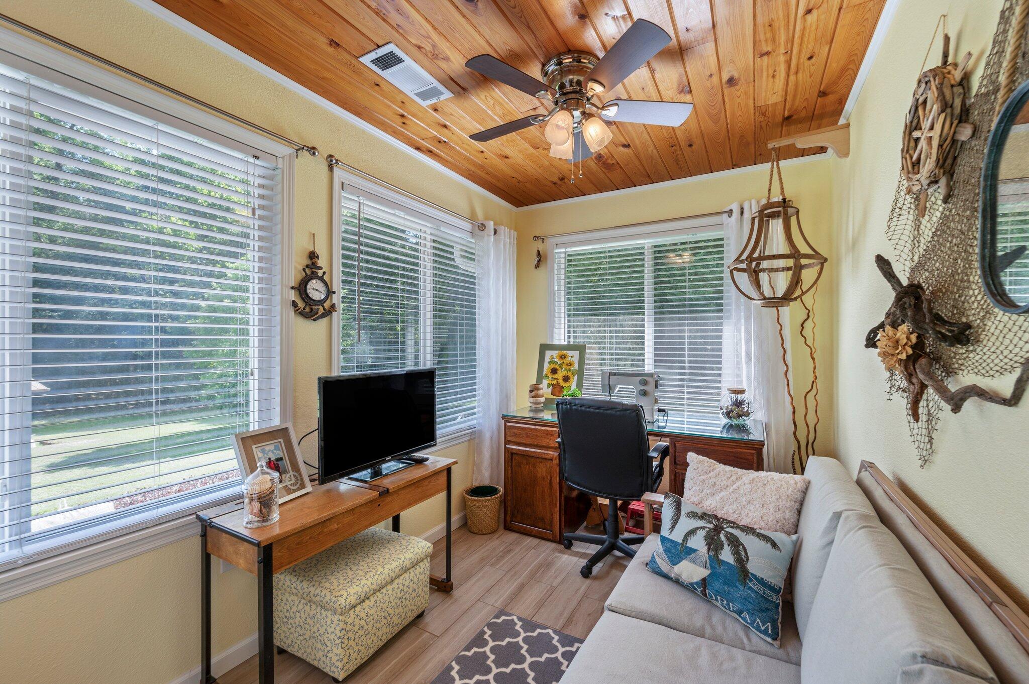 1084 Reeves Road Baker, FL 32531 - Photo 27 of 37 a living room with furniture a flat screen tv and a window