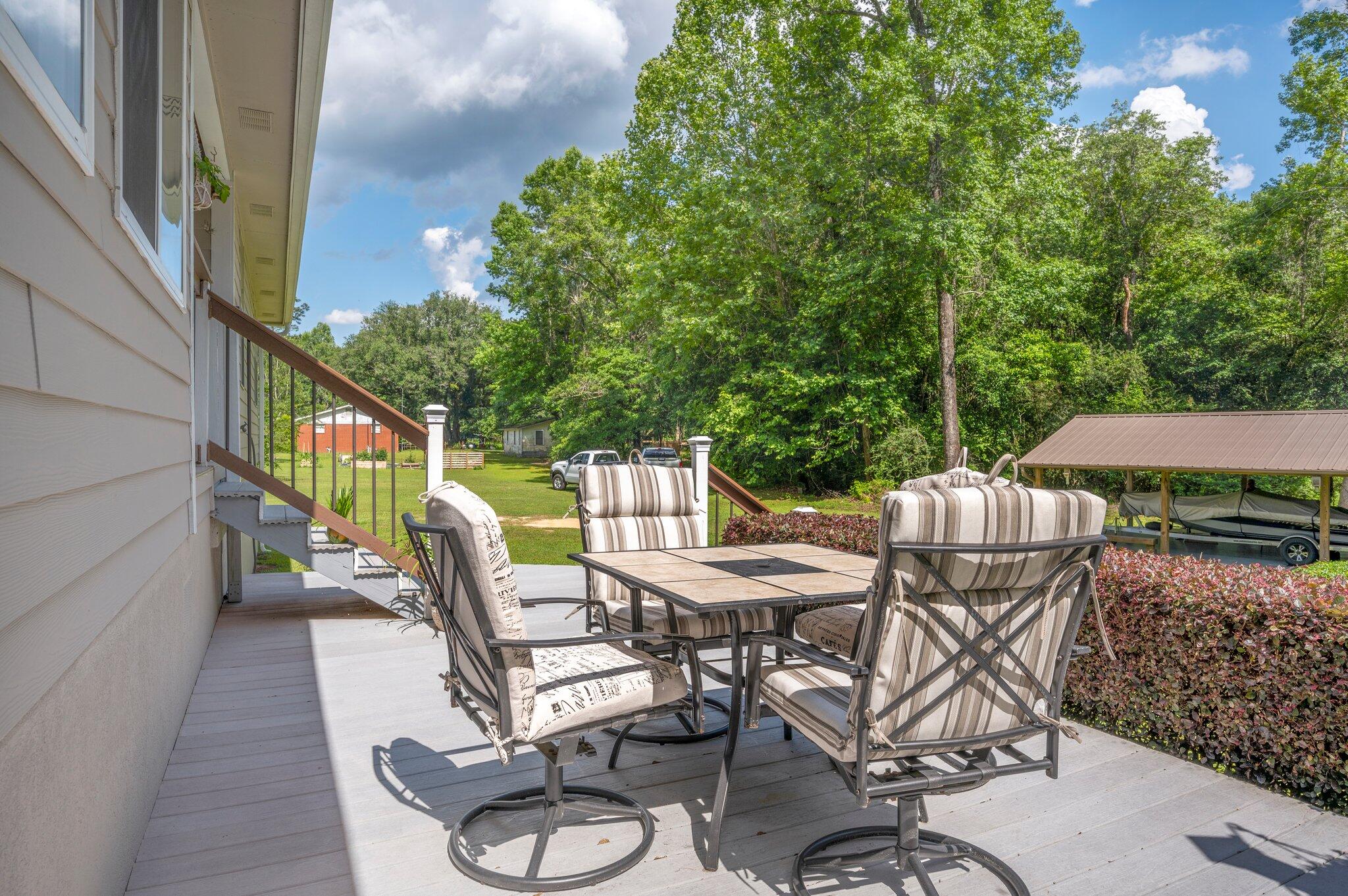 1084 Reeves Road Baker, FL 32531 - Photo 31 of 37 a view of a chairs and table in patio
