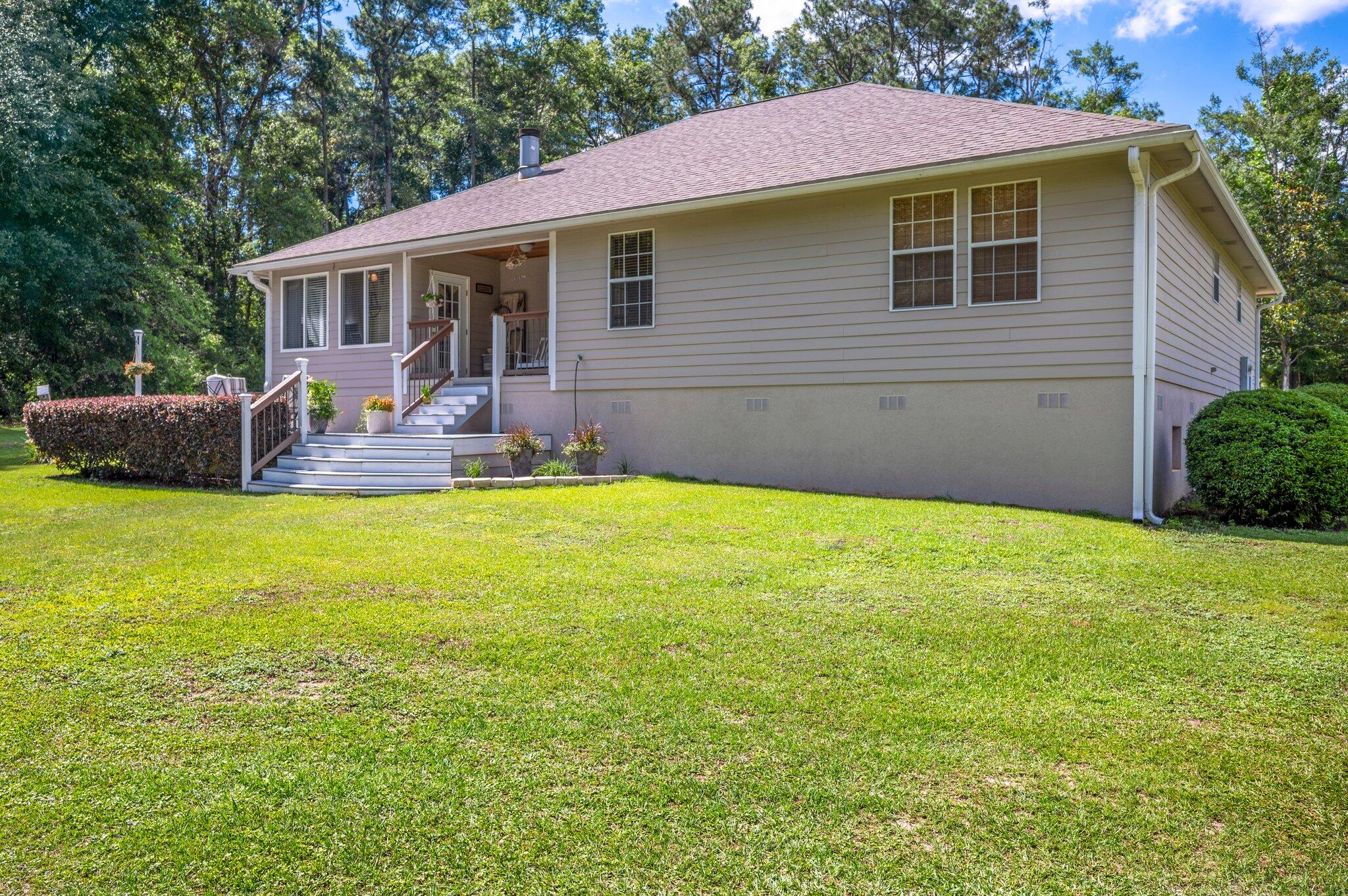1084 Reeves Road Baker, FL 32531 - Photo 32 of 37 a view of house with backyard and outdoor seating