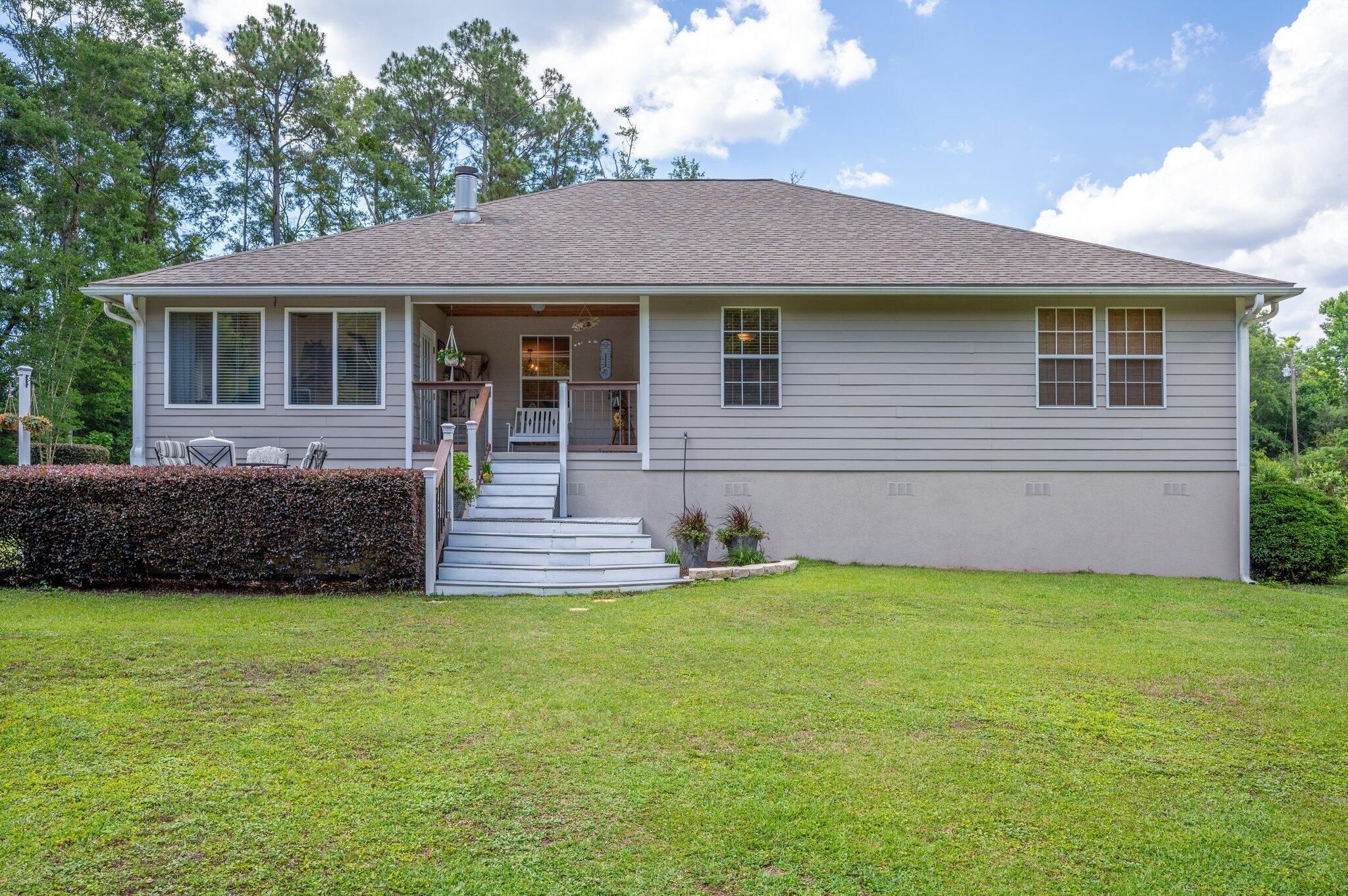 1084 Reeves Road Baker, FL 32531 - Photo 33 of 37 a view of a house with a yard and a garden