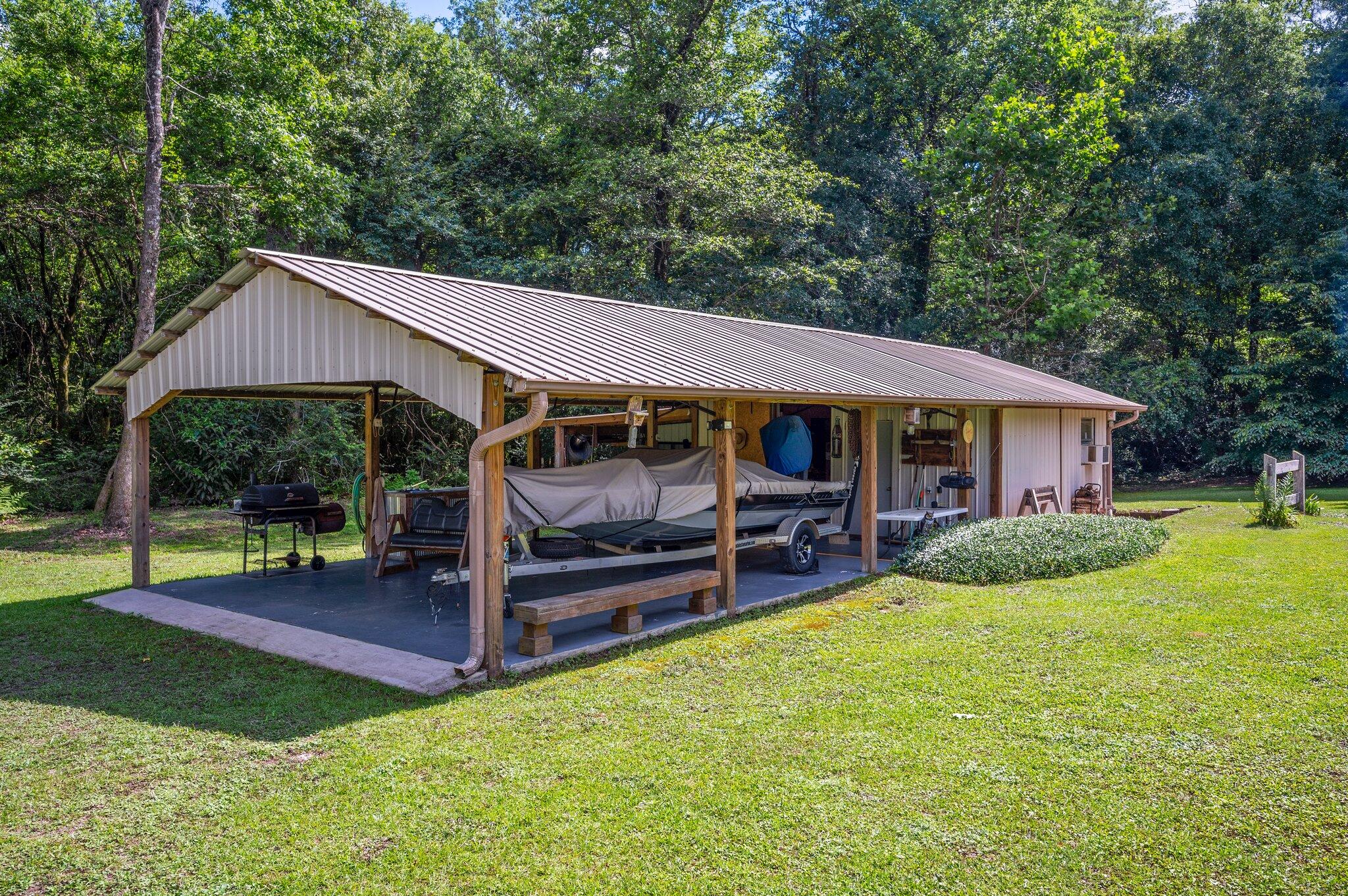 1084 Reeves Road Baker, FL 32531 - Photo 35 of 37 a patio with sofas fire pit table and chairs
