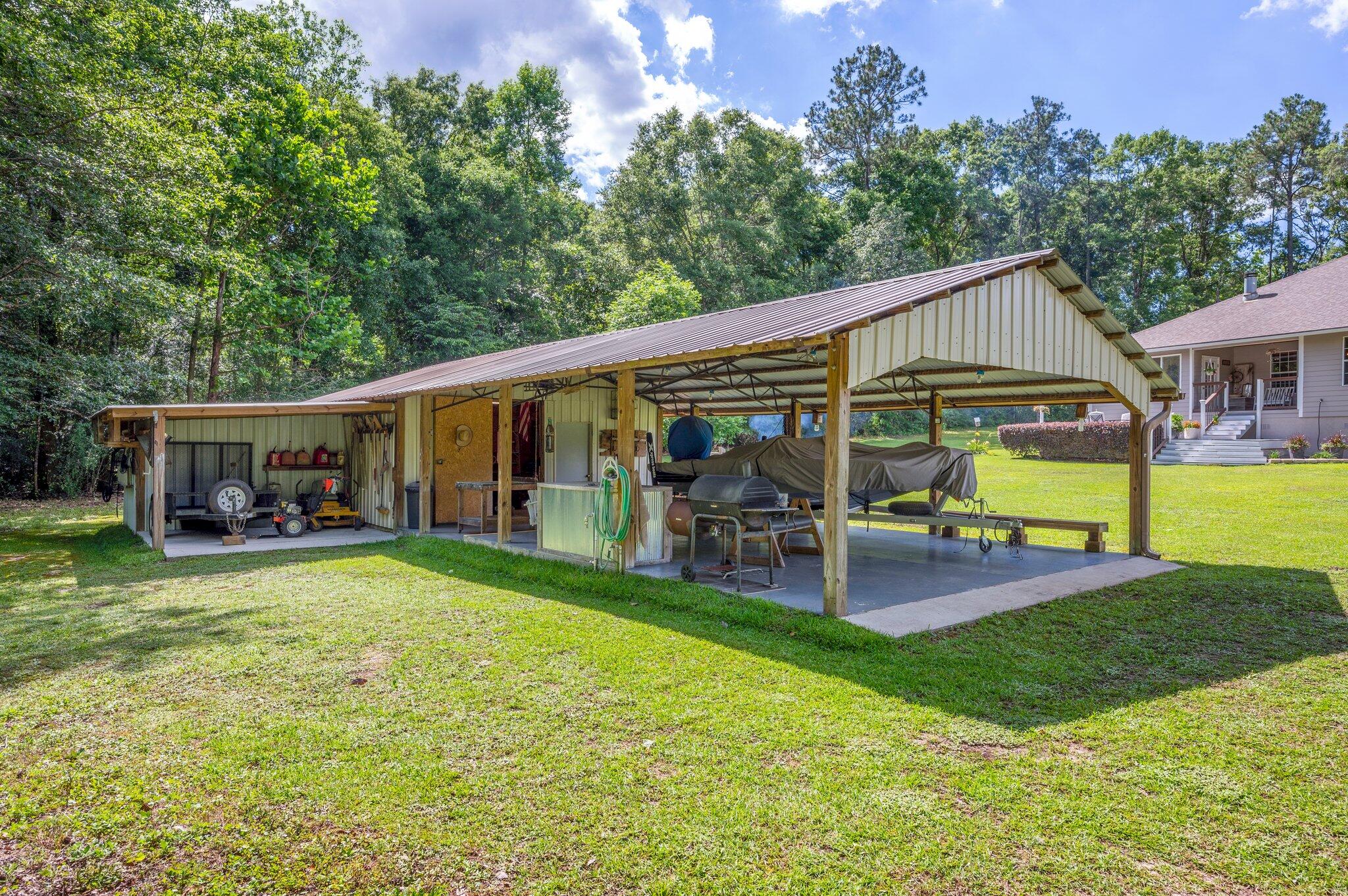 1084 Reeves Road Baker, FL 32531 - Photo 36 of 37 a view of a house with backyard porch and sitting area