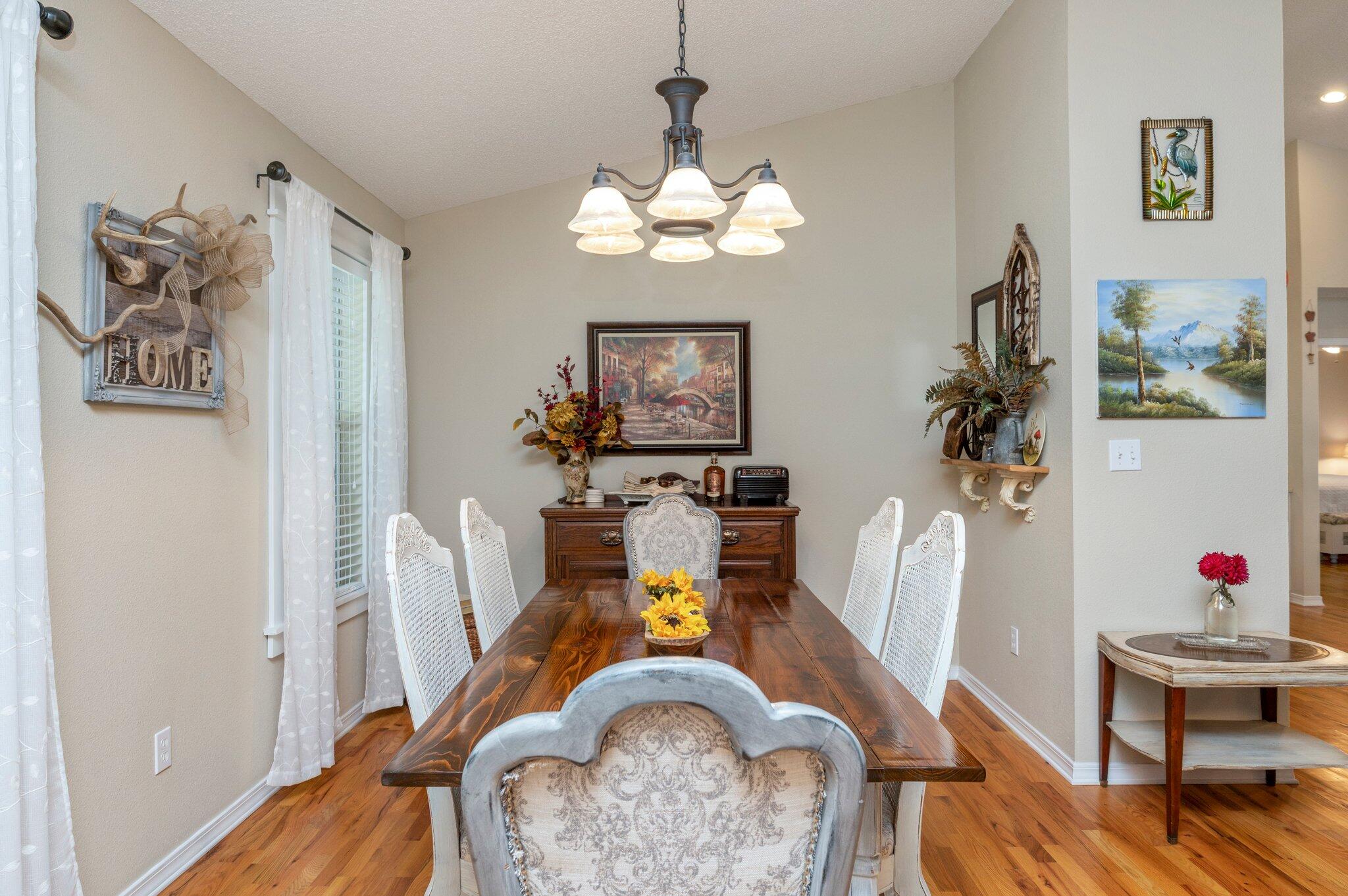 1084 Reeves Road Baker, FL 32531 - Photo 5 of 37 a view of a dining room with furniture wooden floor and a chandelier