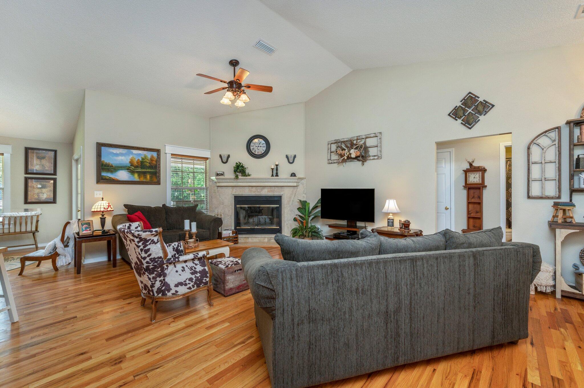 1084 Reeves Road Baker, FL 32531 - Photo 7 of 37 a living room with furniture a fireplace and a flat screen tv