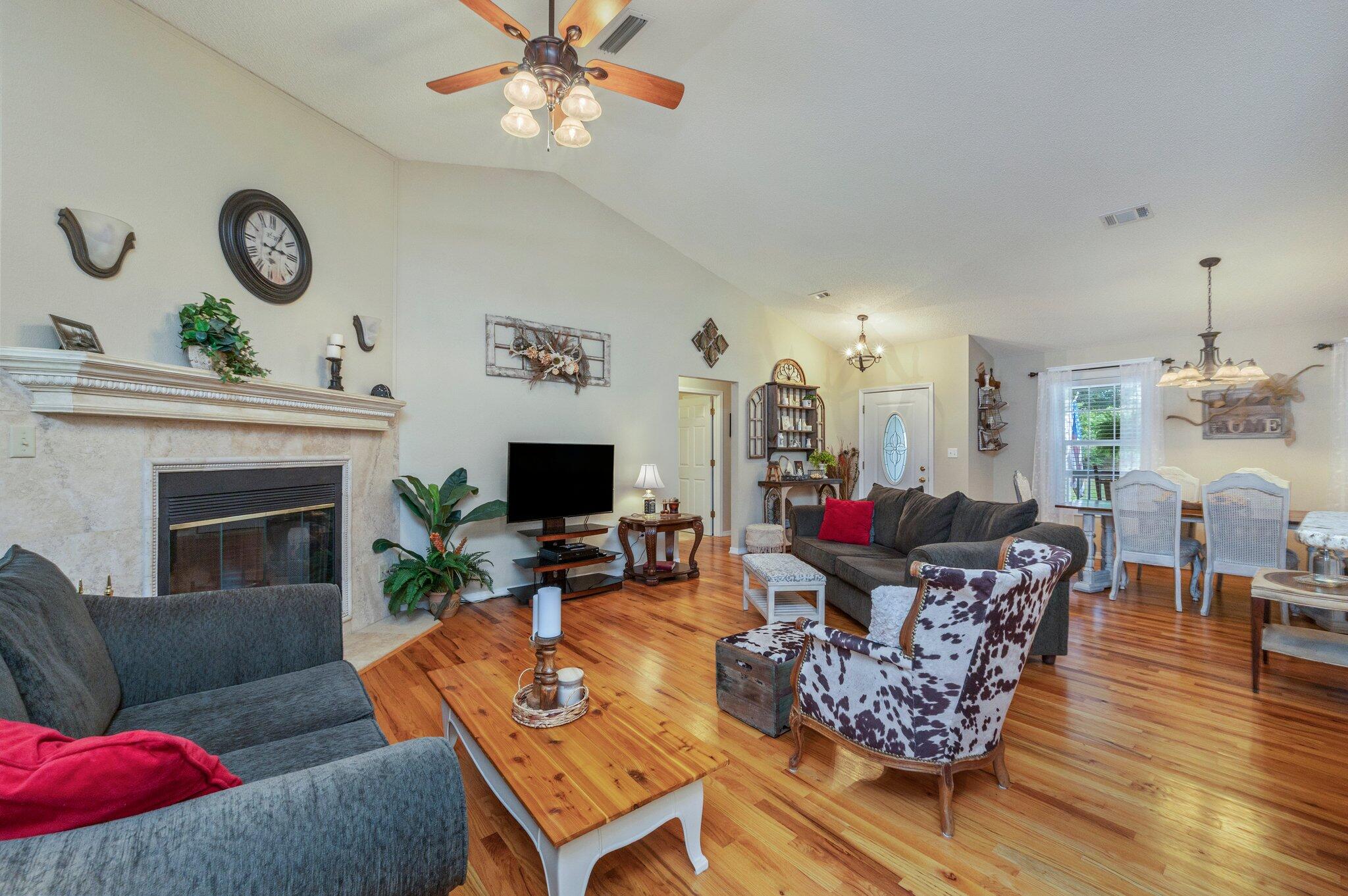 1084 Reeves Road Baker, FL 32531 - Photo 8 of 37 a living room with furniture a flat screen tv and a fireplace