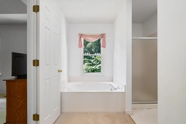 a bathroom with bathtub and shower