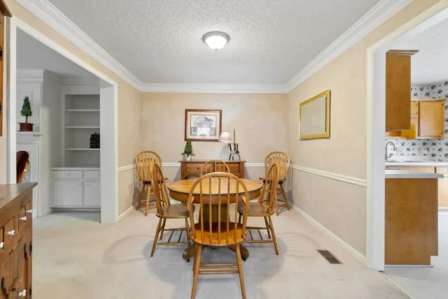 a view of a dining room with furniture and window