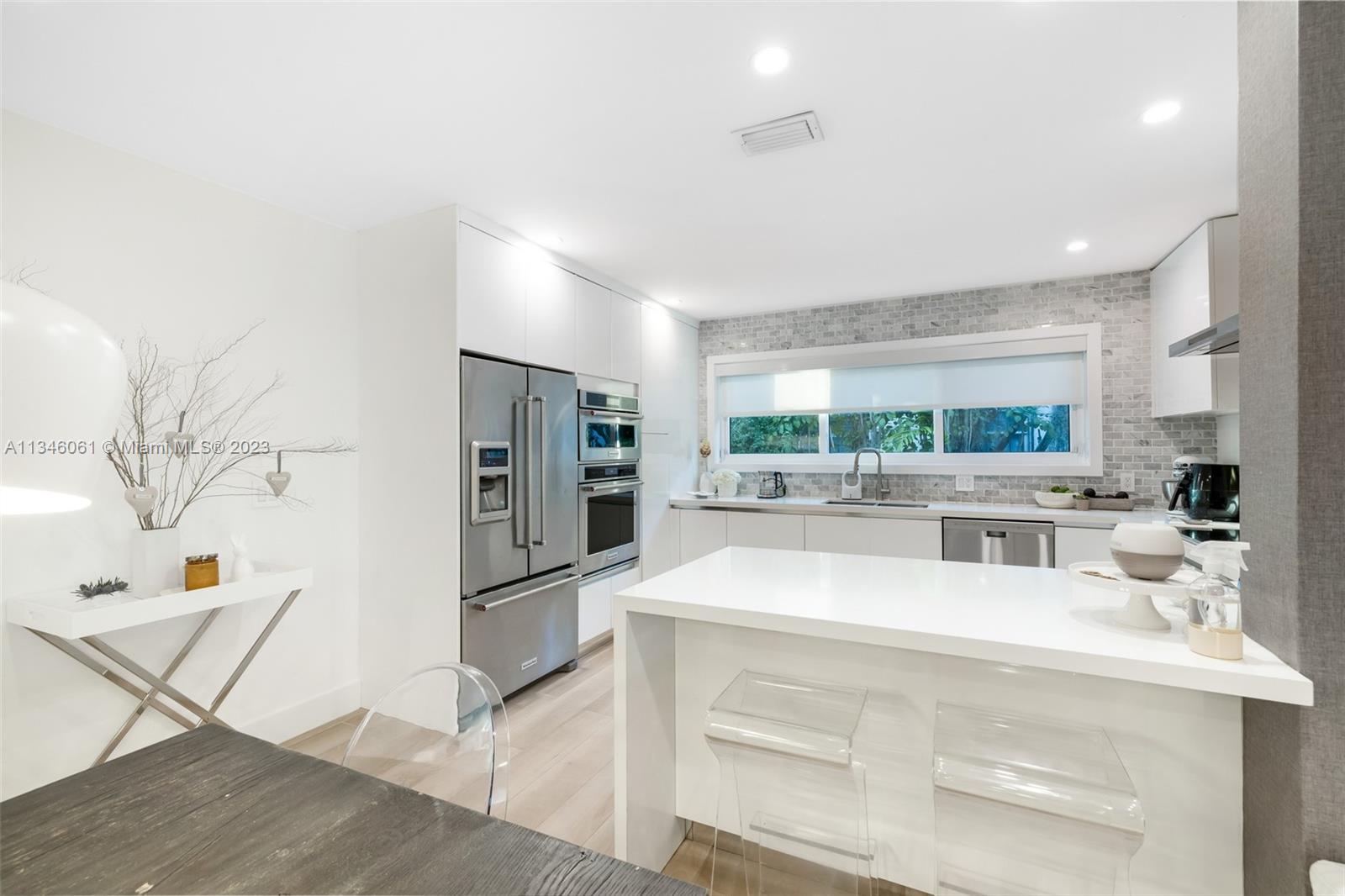 730 Southwest 26th Road Miami, FL 33129 - Photo 11 of 34 a view of kitchen with stainless steel appliances wooden floor and counter space