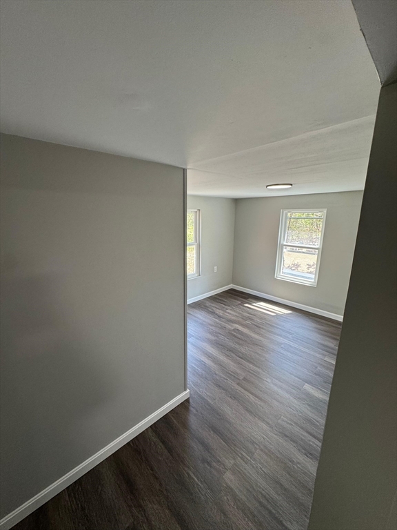32 Main Street Monson, MA 01057 - Photo 32 of 42 an empty room with wooden floor and window