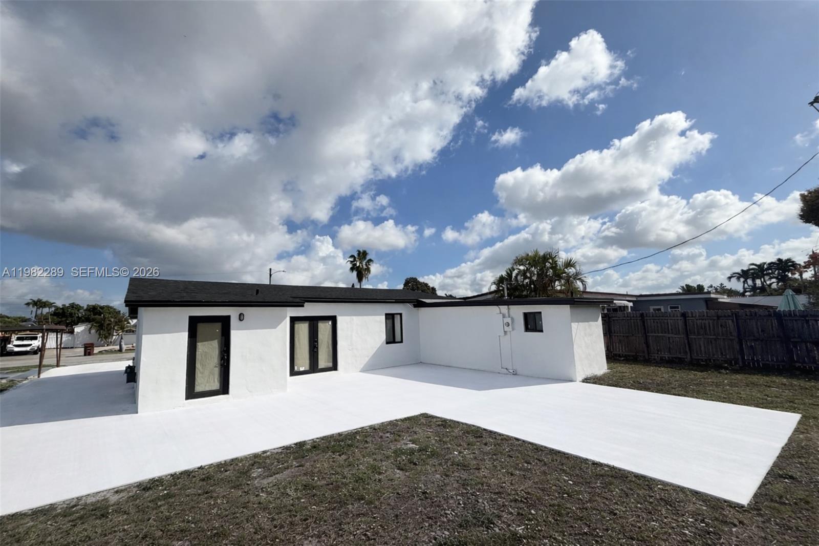 1014 West 66th Street Hialeah, FL 33012 - Photo 12 of 43 a front view of a house with a yard and garage