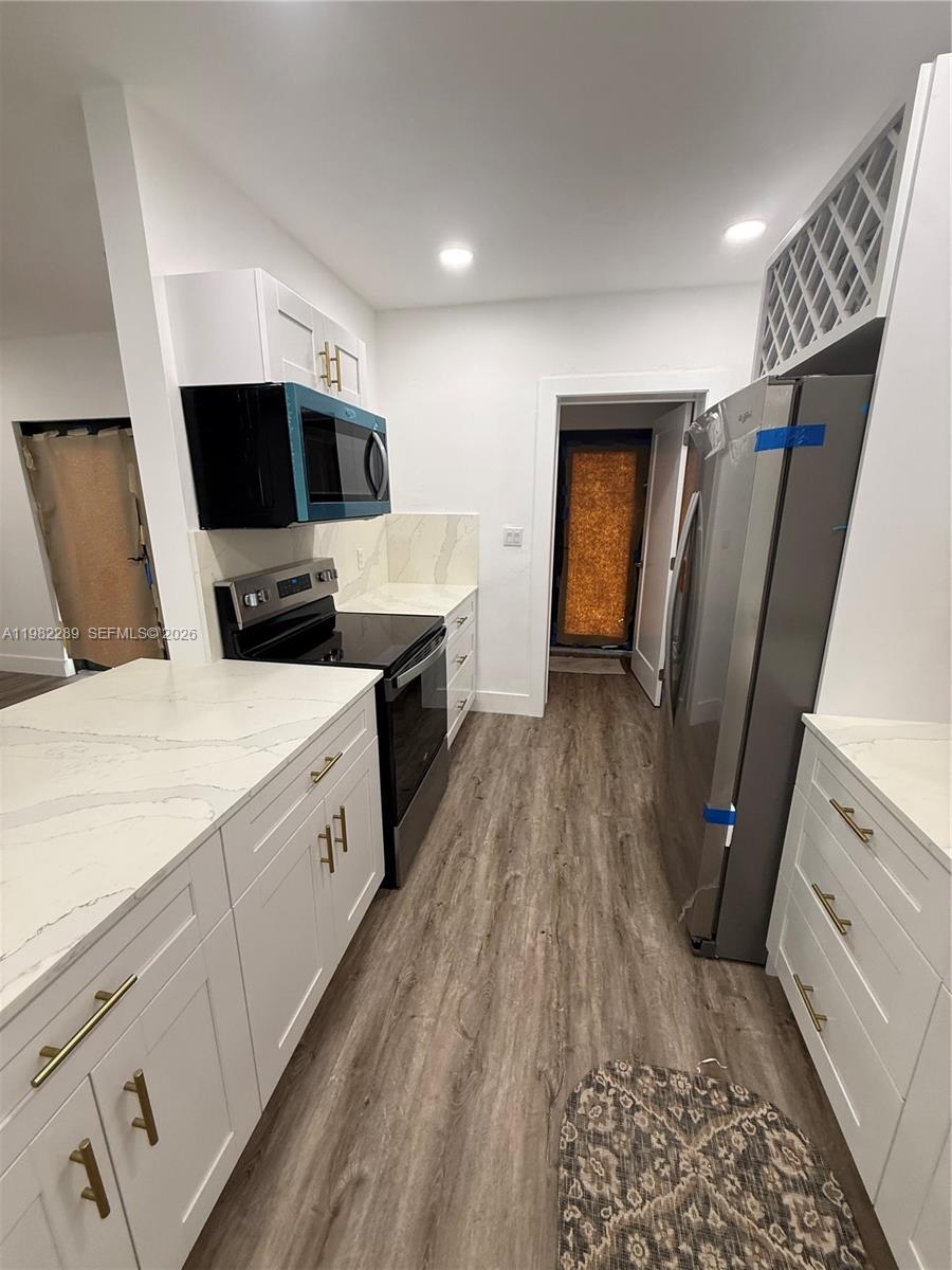 1014 West 66th Street Hialeah, FL 33012 - Photo 24 of 43 a view of a kitchen with electric appliances