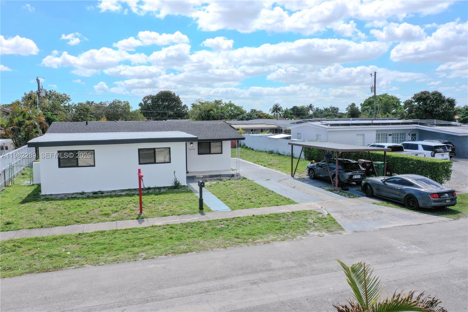 1014 West 66th Street Hialeah, FL 33012 - Photo 3 of 43 a view of house with outdoor space and car parked