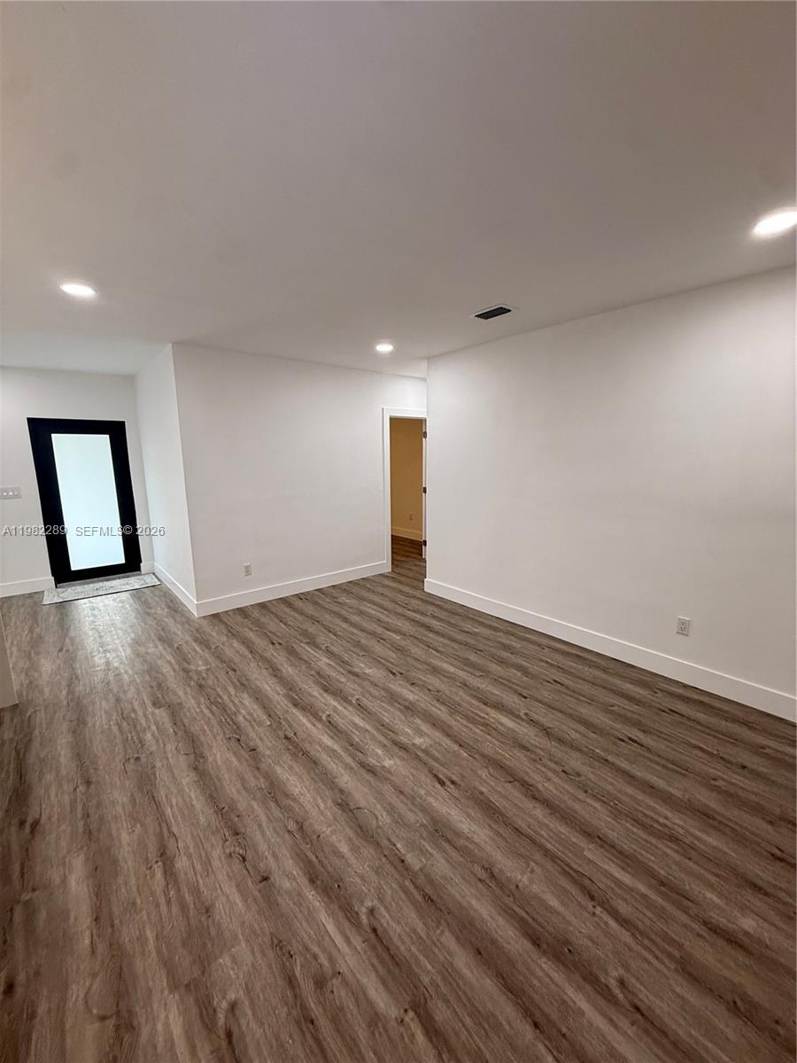 1014 West 66th Street Hialeah, FL 33012 - Photo 33 of 43 a view of a room with wooden floor and window
