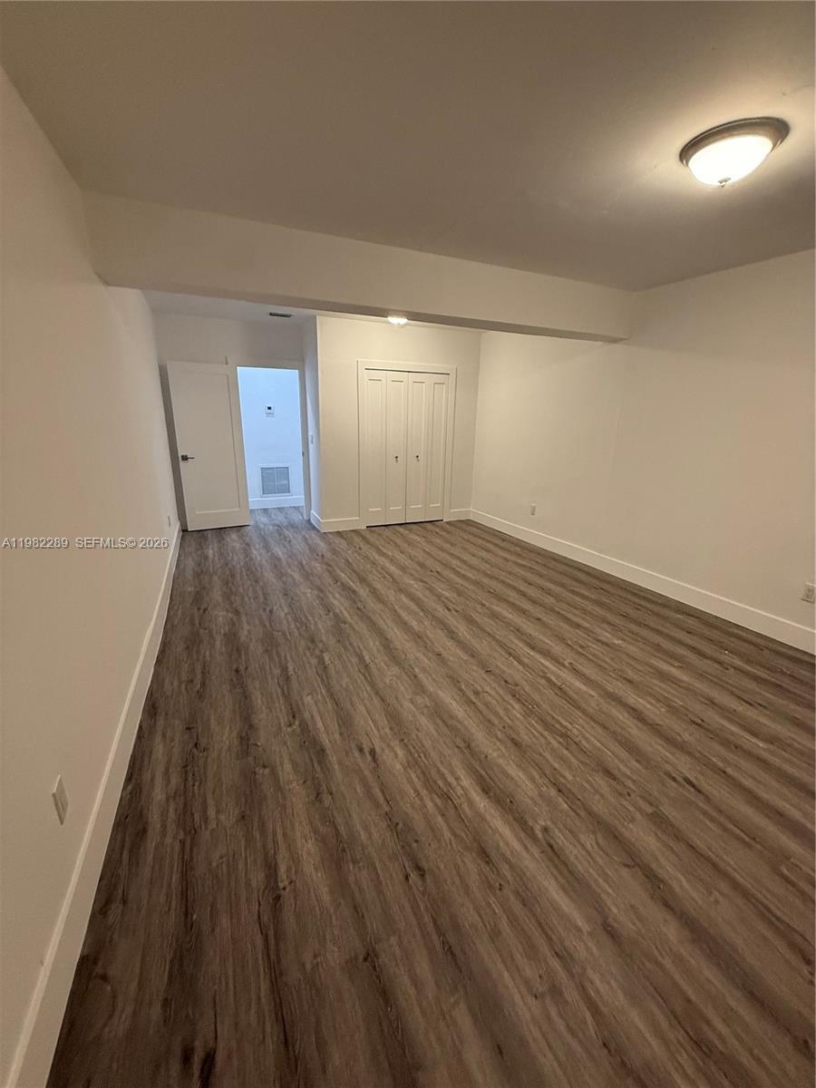 1014 West 66th Street Hialeah, FL 33012 - Photo 34 of 43 wooden floor in an empty room with a window