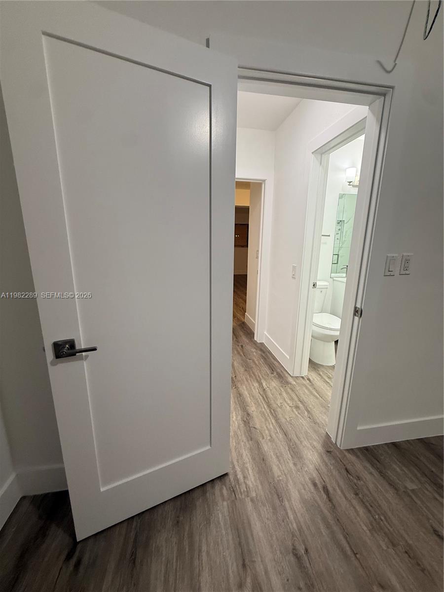 1014 West 66th Street Hialeah, FL 33012 - Photo 39 of 43 an empty room with wooden floor and entrance