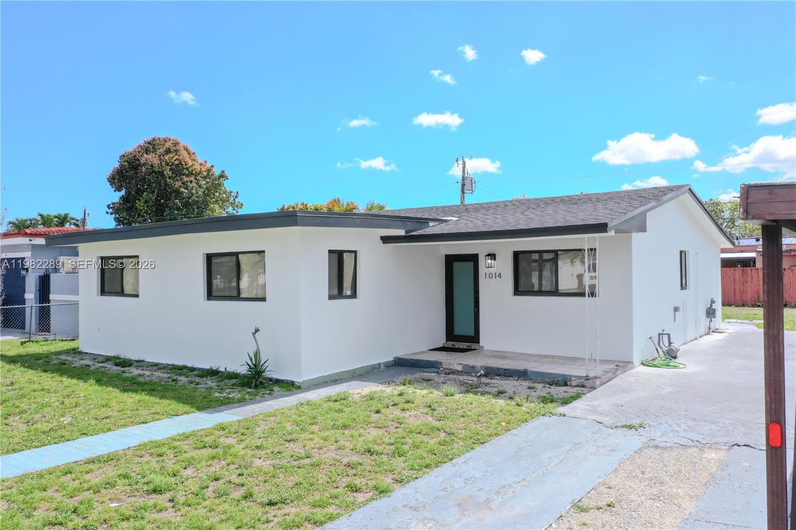 1014 West 66th Street Hialeah, FL 33012 - Photo 4 of 43 a house view with a backyard space