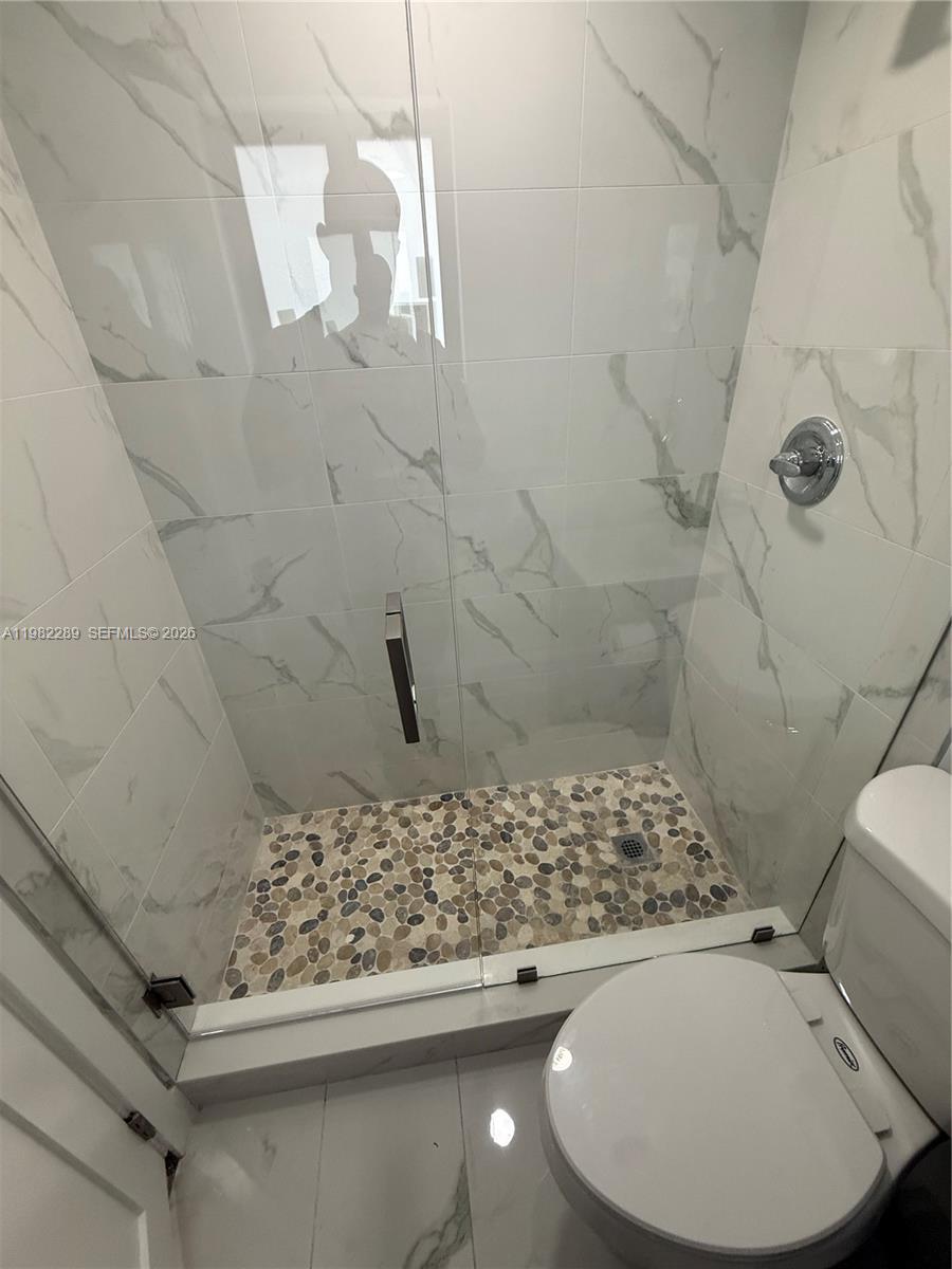 1014 West 66th Street Hialeah, FL 33012 - Photo 42 of 43 a bathroom with a toilet and a shower