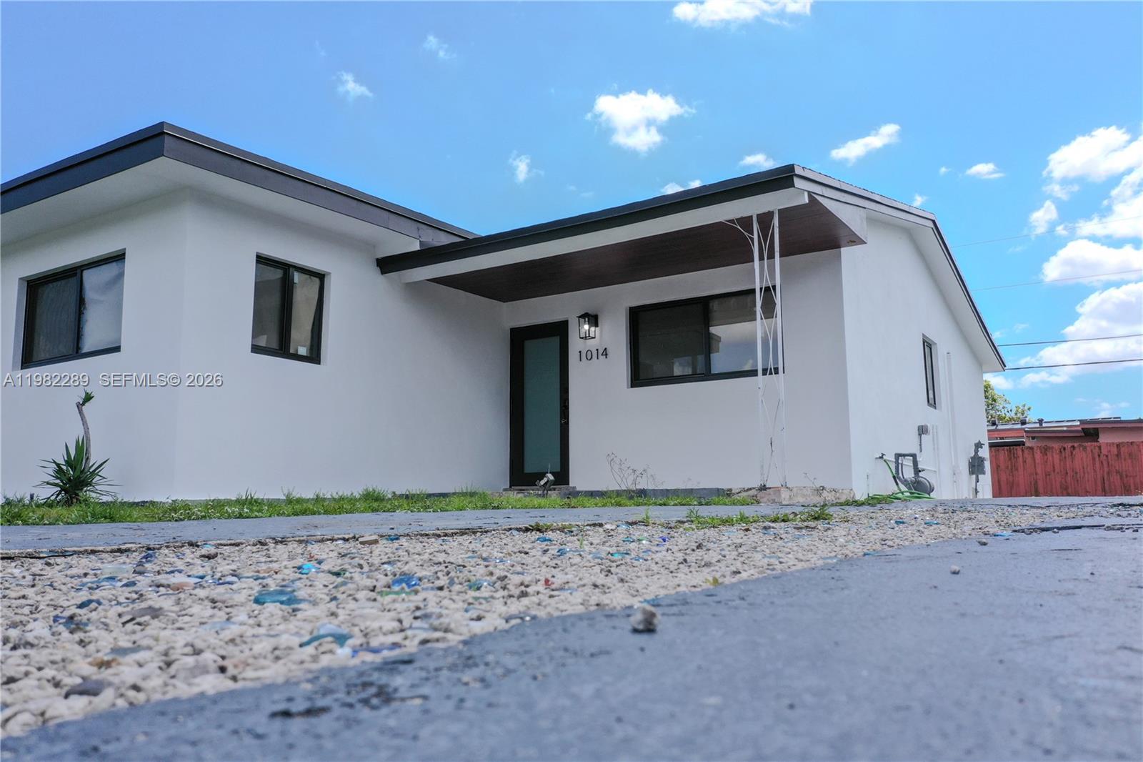 1014 West 66th Street Hialeah, FL 33012 - Photo 5 of 43 a front view of a house with lots of plants