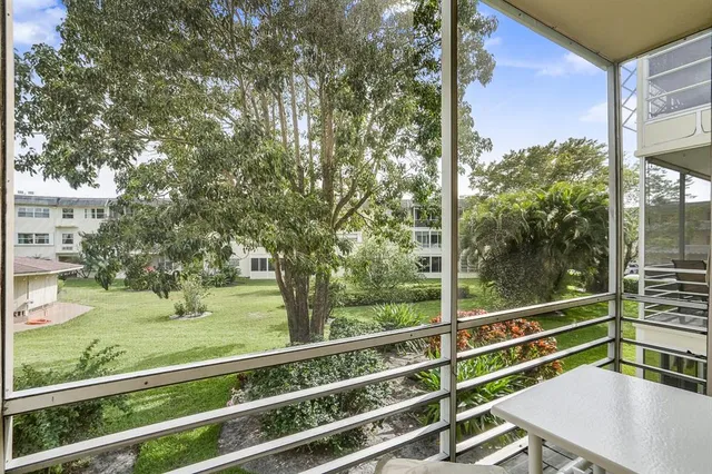 a view of a balcony with yard