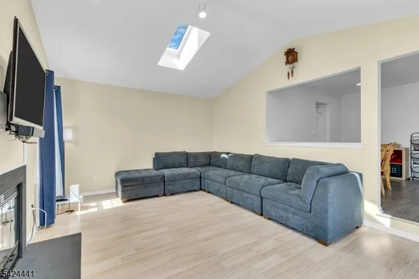 a living room with couches and a flat screen tv