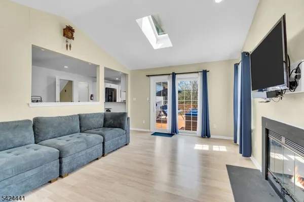 a living room with furniture flat screen tv and a fireplace