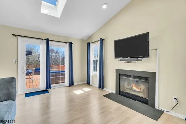 a view of a livingroom with a fireplace and a window