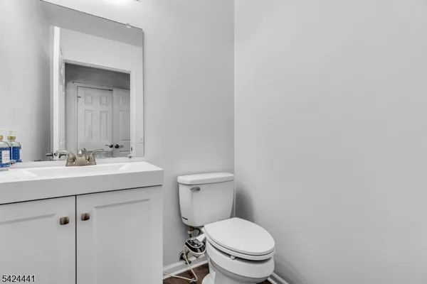 a bathroom with a toilet a sink and mirror