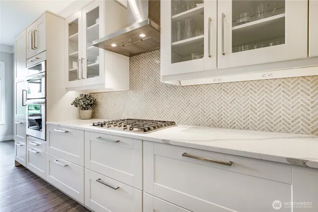 a kitchen with granite countertop white cabinets and white appliances