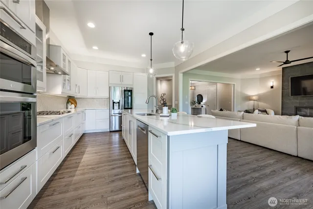 a large kitchen with cabinets and wooden floor